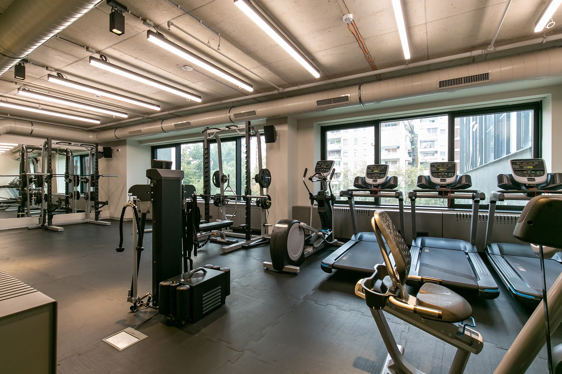 Moderner Trainingsbereich im Le Gym mit Kraftgeräten und Tageslicht